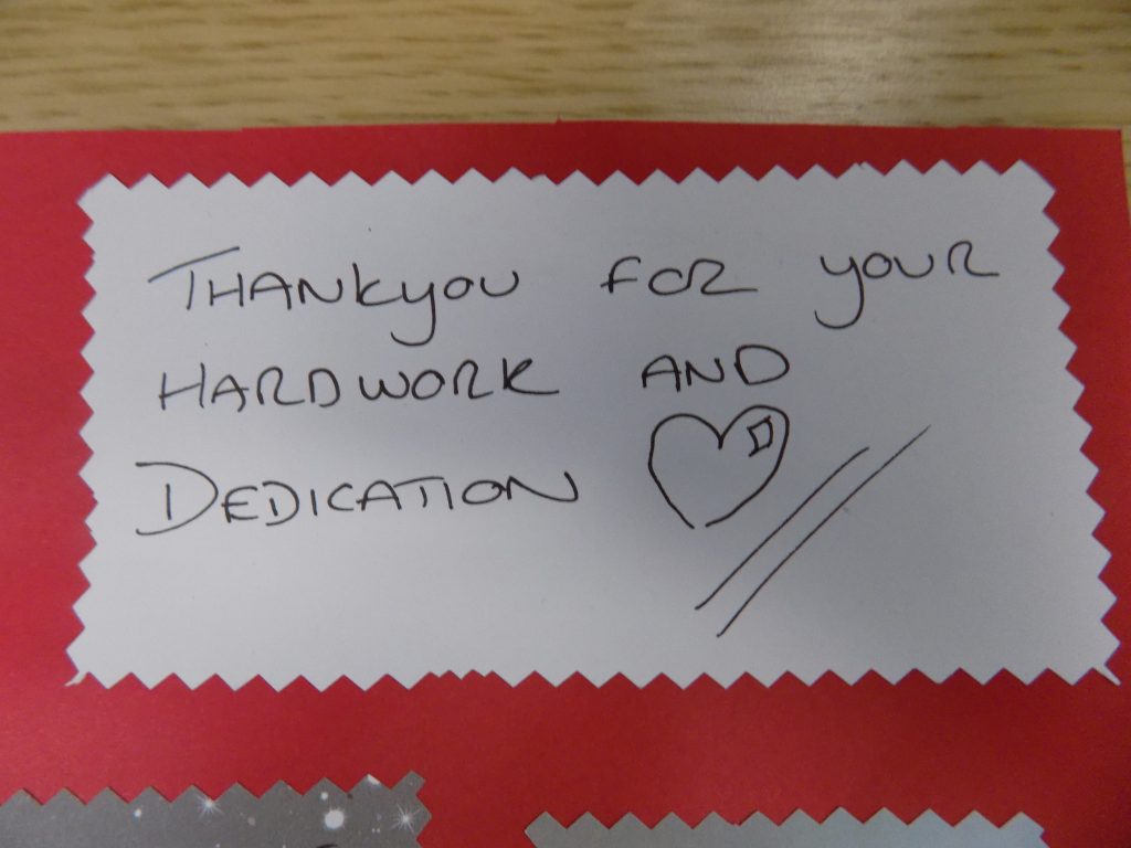 QE Charitable funds receiving a thank you letter from Gateshead Recovery Partnership outside ECC