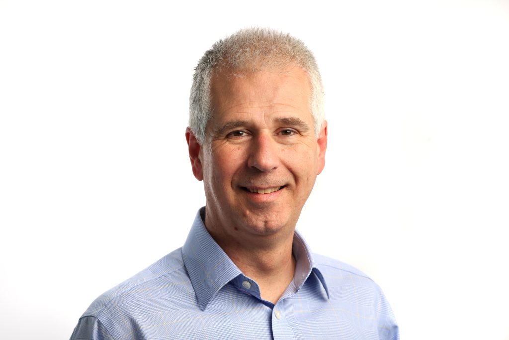 Headshot of Neil Halford against white background.